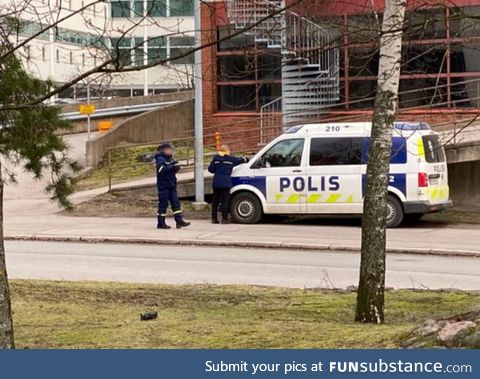 Traffic warden giving a ticket to police in Helsinki, Finland