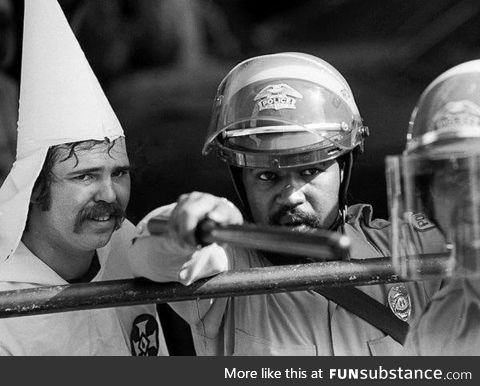 Police protect KKK member as protesters close in during a rally, Austin, Texas, circa