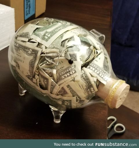 Piggy bank full of two dollar bills I'm giving a friend as a wedding present