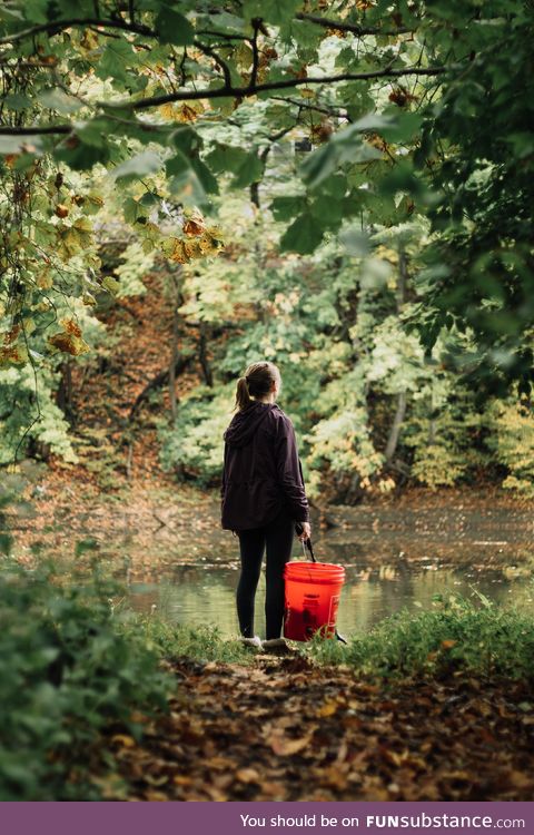 My girlfriend likes to pick up trash while we walk our dog. Here's a shot I took of her