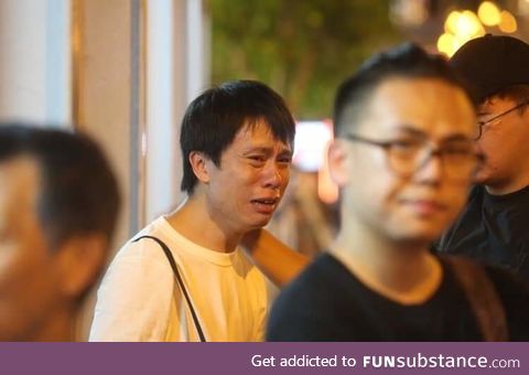 Hong Kong councillor Roy Kwong cries in agony as a protestor commited suicide to protest