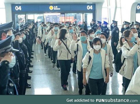Chinese police saluting the heroic doctors and nurses before leaving wuhan