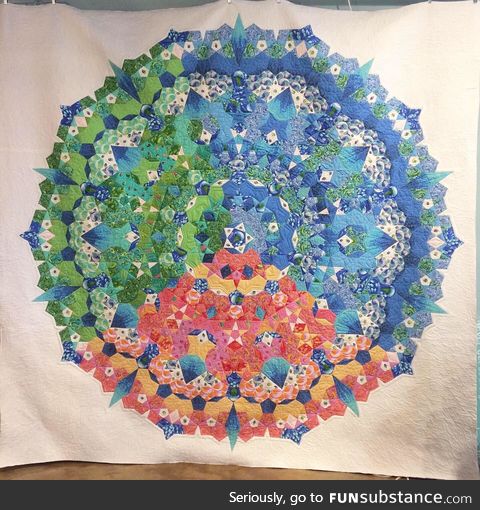 I made this 9 foot tall quilt by hand-sewing 1,288 pieces of fabric together. About