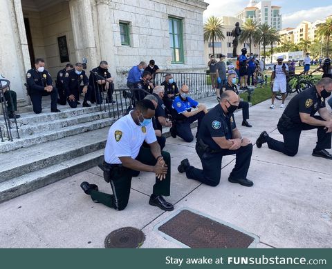 The police taking a knee with protesters in Miami, Florida
