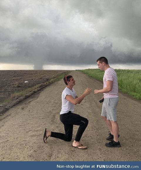 Storm chaser proposes with Kansas tornado in the background