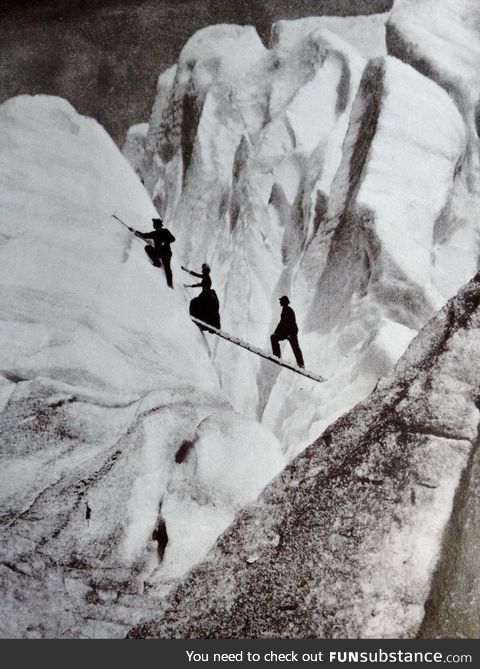 Late Victorian mountaineers cross a crev[ass]e in the Alps, circa 1900
