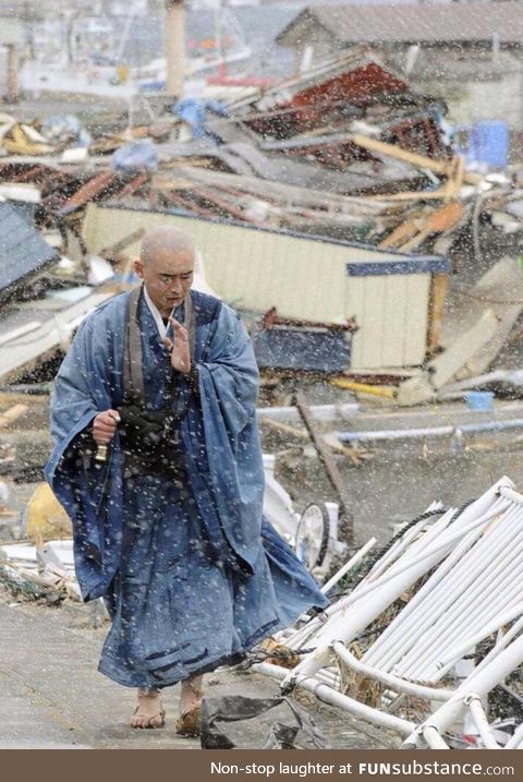 Japanese monk praying for the victims during the 2011 Tohoku earthquake and tsunami