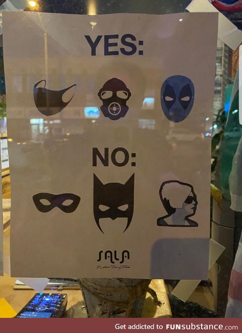 A paper sign in front of a store. That will keep the Karens away!