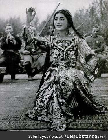 Uighur dancer performing to music, Xinjiang, China, circa 1943