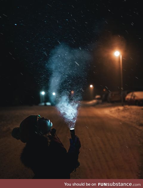 My daughter holding a flashlight in snowy weather