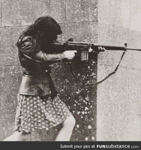 This photograph taken in Ireland in 1972 of a girl shooting from the gun of her fiancé