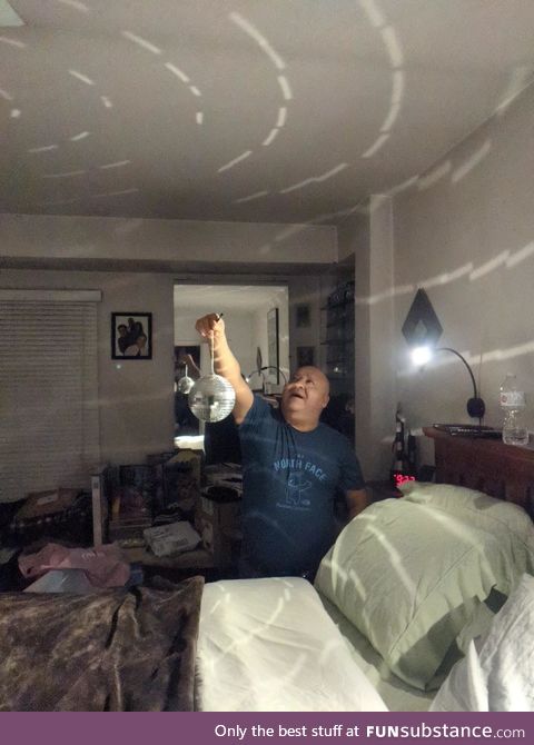 My Dad happily showing me the disco ball he bought for our quarantine new years