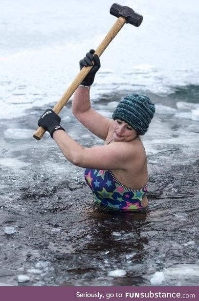 Alice Goodridge breaking the ice at Loch Insh in Scotland before her morning swim