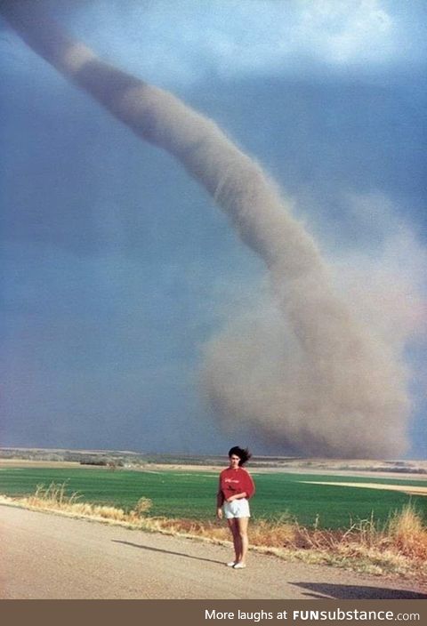 Just a woman posing with a tornado in Nebraska, 1989