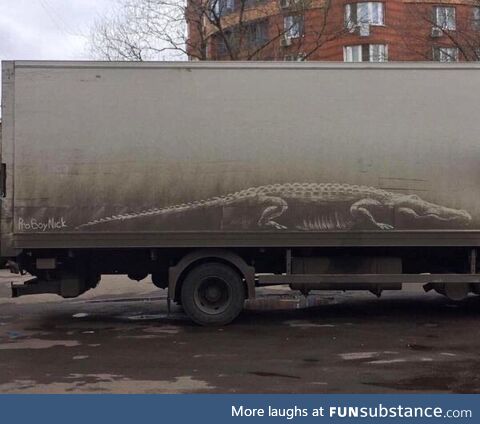 Alligator drawn into dirt on side of a truck