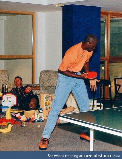 Michael Jordan plays ping pong while Larry Bird gets drunk, taken during the 92 Olympics