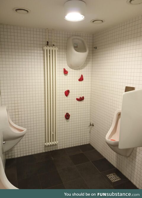 A men's bathroom in a restaurant. Art installation