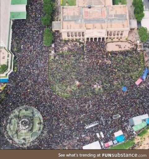 Aerial shot of protestors storming presidential office in sri lanka