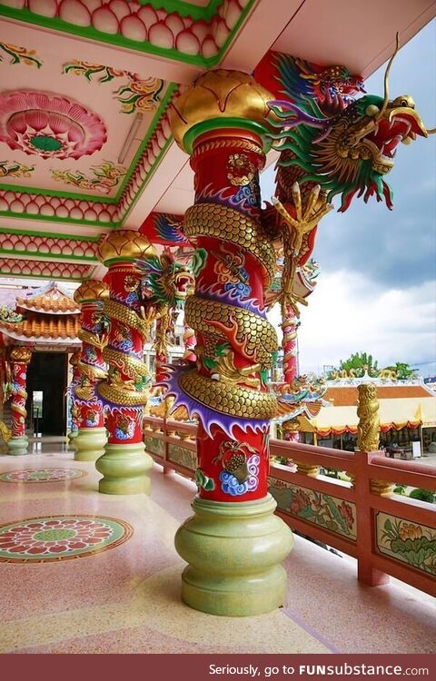 Golden dragons coiled round pillars at the Naja Shrine, Chinese temple at Angsila,