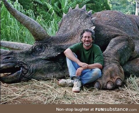 A hunter with the last remaining dinosaur he killed, making these animals officially