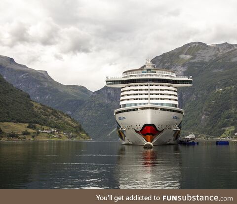 The "MS Let me Speak to your Manager" docking at Geirangerfjorden