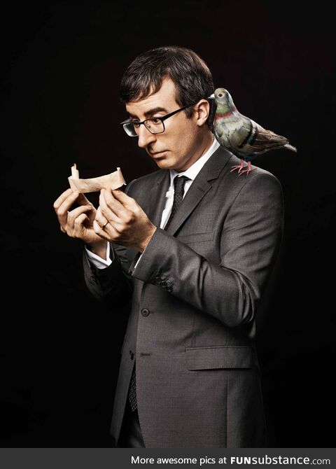 Our boi John Oliver looking through pics of him in pics