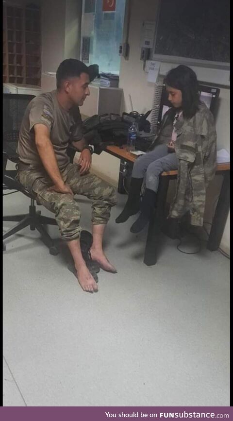 An Azerbaijani peacekeeper with an Afghan girl