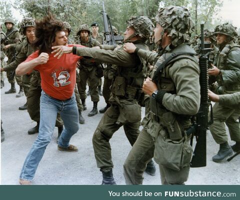 Mohawk warrior attacks Canadian soldiers during Oka crisis July-Sep 1990 which began when