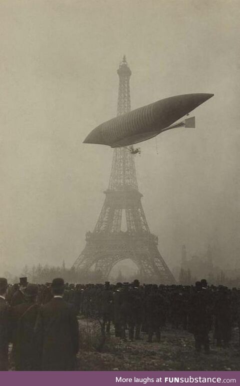 An early airship flies near the Eiffel Tower in Paris circa 1905