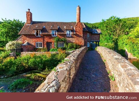 House besides a bridge and river in South West England