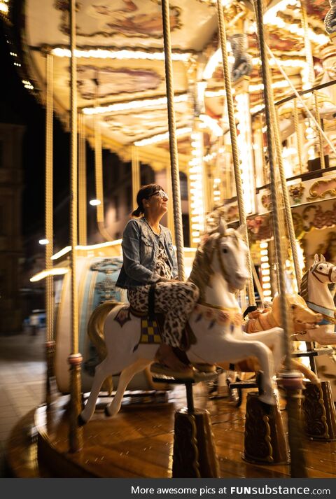 A happy lady on the carousel in Strasbourg, France