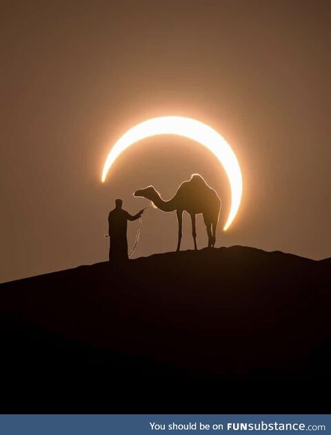 Perfectly timed photo of an eclipse around a man and a camel in by photographer Joshua