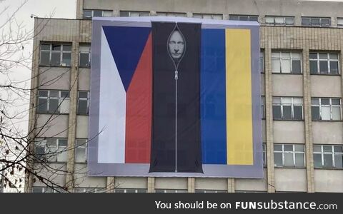 Putin in a body bag alongside the Czech and Ukrainian flags on the side of the Czech Int
