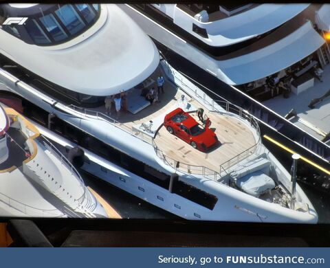 A ferrari f40 on a lazy Susan at the front of a yacht deck