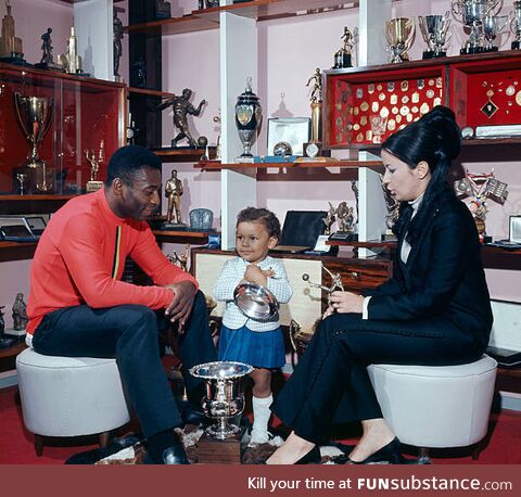 Soccer legend Pelé at home with his third wife Rosemeri, some trophies, and unidentified