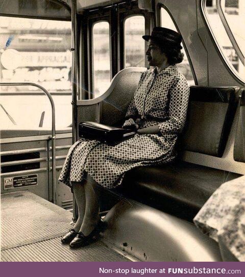 Rosa Parks sits at the front of a bus following the end of segregation by the transit