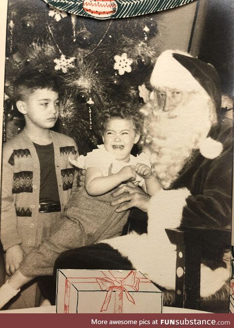 My terrified mother and unimpressed uncle meeting Santa 1955