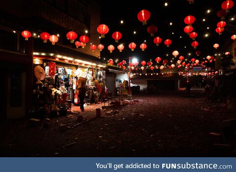 Store owner cleaning up after Lunar new year festivities in Chinatown