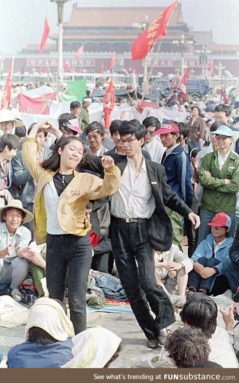 Students dance in Tiananmen Square shortly before the arrival of the Chinese military,