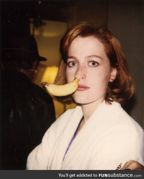 Gillian Anderson with a banana in her nose