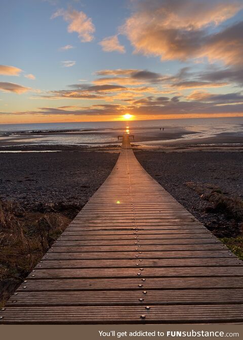 The sun setting over the pier at Seascale Beach, Cumbria