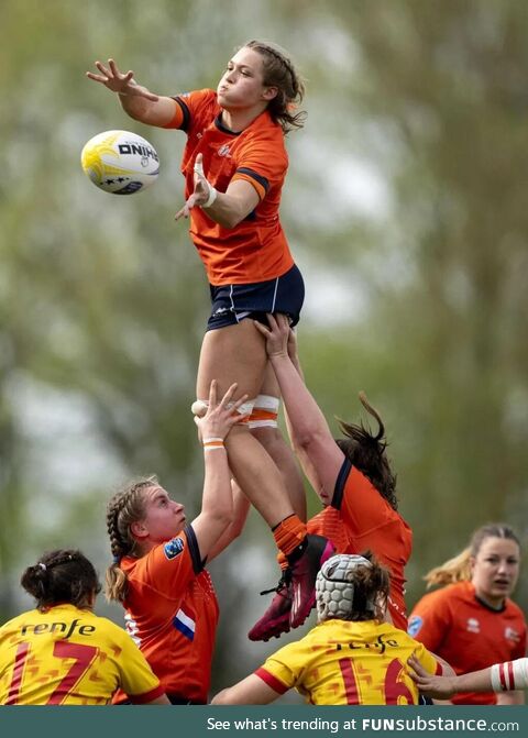 Isa Prins is lifted by her Dutch teammates during the Women's Rugby European Championship