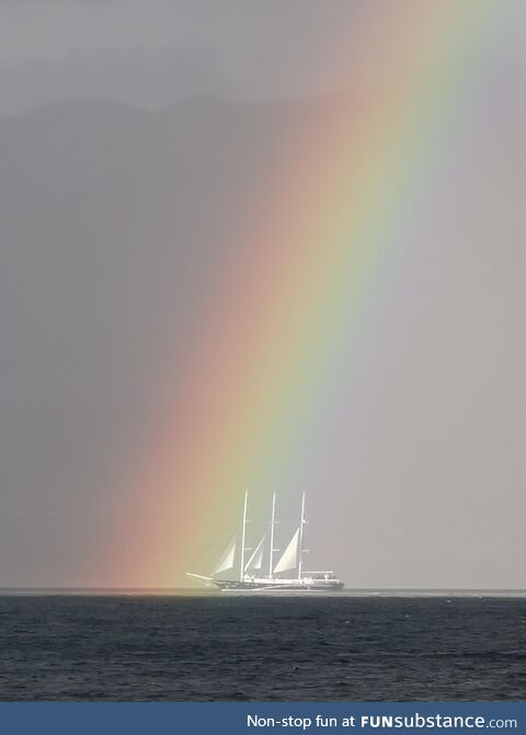 Sailing ship entering the rainbow