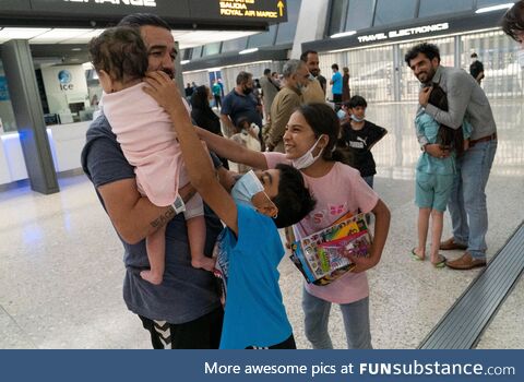 A family from Afghanistan arrives at Dulles International Airport in Chantilly, Virginia