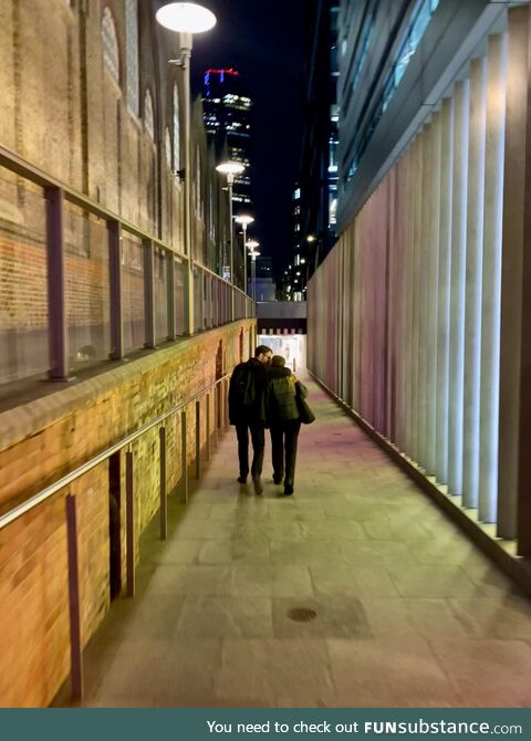 London. Late night walk home behind some happy people