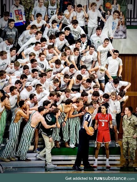 Student fans at a local HS basketball game yelling at an opposing player