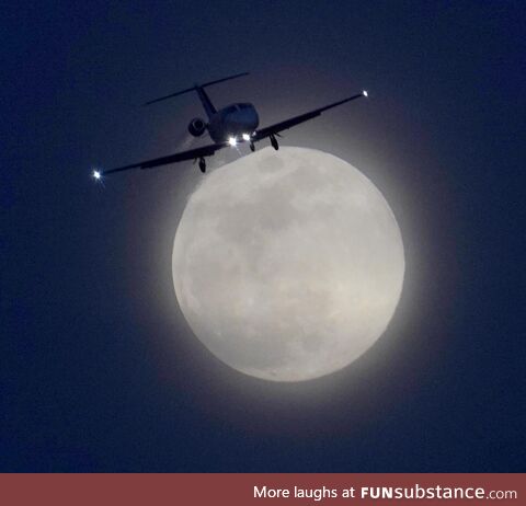 Full Snow Moon with a jet brushing off its top!