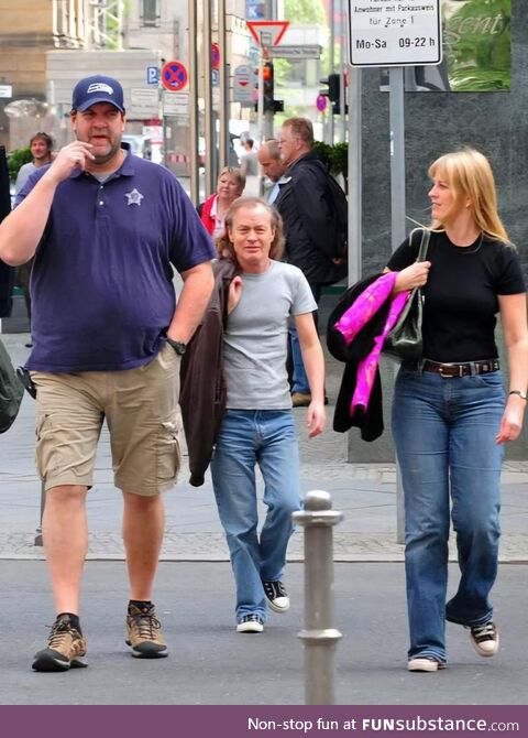 Angus Young of AC/DC with his wife and bodyguard