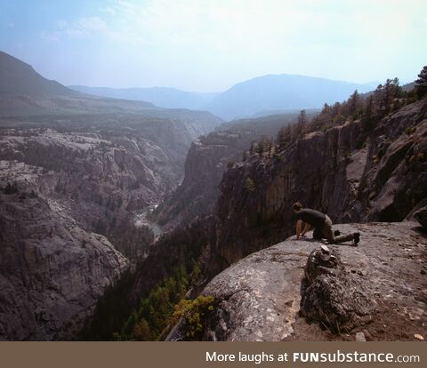 A coworker overlooking a cliff in Beartooth pass, Wyoming