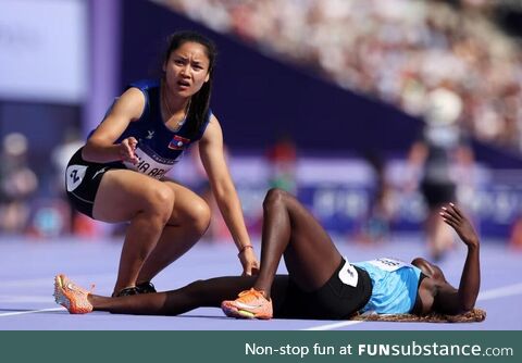 Silina Pha Aphay (Laos) comforting Lucia Moris (South Sudan) after a fall in the woman's